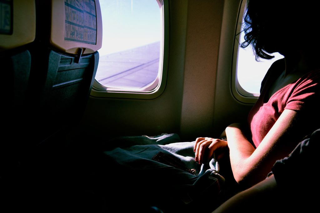 girl looking out the plane window